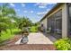 Outdoor living space with a gas grill, dining set, screened-in porch, and lush landscaping at 16246 26Th E St, Parrish, FL 34219