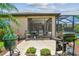 Backyard patio features a seating area, lush landscaping, and a screened lanai at 16246 26Th E St, Parrish, FL 34219
