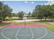 An outdoor basketball court surrounded by trees, a sand volleyball court and picnic tables at 16246 26Th E St, Parrish, FL 34219