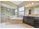 Bathroom boasts a soaking tub with tile surround, walk-in shower, and a spacious vanity with great lighting at 16246 26Th E St, Parrish, FL 34219