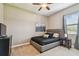 Cozy bedroom with neutral tones, carpet, ceiling fan, and natural light from a window at 16246 26Th E St, Parrish, FL 34219
