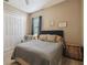 Comfortable bedroom featuring neutral tones, a cozy chair, and natural light from a window at 16246 26Th E St, Parrish, FL 34219
