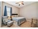 Cozy bedroom with a sitting area, featuring soft natural light and a comfortable chair at 16246 26Th E St, Parrish, FL 34219