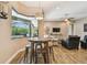 Casual breakfast nook with windows overlooking pool and living area with fan and TV at 16246 26Th E St, Parrish, FL 34219
