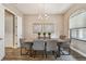 Dining room featuring seating for six, wood-look tile, natural light, and contemporary decor at 16246 26Th E St, Parrish, FL 34219