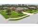 Landscaped yard with decorative trees and a long driveway to the side entry garage at 16246 26Th E St, Parrish, FL 34219
