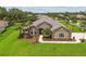 A meticulously landscaped yard surrounds this single-story home, complete with a sidewalk and palm trees at 16246 26Th E St, Parrish, FL 34219