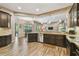 Spacious kitchen with granite countertops, dark wood cabinets, stainless steel appliances, and wood-look tile flooring at 16246 26Th E St, Parrish, FL 34219