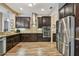 Well-equipped kitchen with stainless appliances, granite countertops and dark wood cabinets at 16246 26Th E St, Parrish, FL 34219