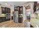 Modern kitchen with dark cabinetry, stainless steel appliances, and granite countertops at 16246 26Th E St, Parrish, FL 34219