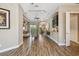 Spacious living area with wood-look tile flooring and coffered ceilings at 16246 26Th E St, Parrish, FL 34219