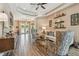 Open living room with wood-look tile, tray ceiling, comfortable seating, and double-door entryway at 16246 26Th E St, Parrish, FL 34219