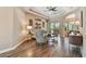 Bright living room with modern decor, tray ceilings, wood-look tile, and comfortable seating arrangement at 16246 26Th E St, Parrish, FL 34219
