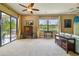 Living room featuring a ceiling fan, a view of the backyard, and neutral-colored walls at 16246 26Th E St, Parrish, FL 34219