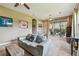 Spacious living room with ceiling fan, neutral walls, and sliding glass doors to the screened pool area at 16246 26Th E St, Parrish, FL 34219