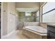 Elegant bathroom featuring an octagonal soaking tub with mosaic tile surround and a frameless shower enclosure at 16246 26Th E St, Parrish, FL 34219
