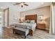Well-lit bedroom with wood floors, a ceiling fan, and warm decor creating a cozy and inviting space at 16246 26Th E St, Parrish, FL 34219