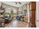Home office with wood-look tile floors, large windows, and custom decor at 16246 26Th E St, Parrish, FL 34219