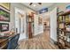 View of a home office with wood-look tile flooring and access to other rooms at 16246 26Th E St, Parrish, FL 34219