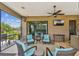 Comfortable outdoor living with an outdoor ceiling fan, mounted TV, and tile flooring in the screened patio at 16246 26Th E St, Parrish, FL 34219