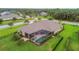 An aerial view of a home featuring a screened-in pool and lush landscaping at 16246 26Th E St, Parrish, FL 34219