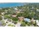 Aerial view of the home and neighborhood featuring lush green trees, beautiful water views, and stunning city skyline at 1671 South Dr, Sarasota, FL 34239