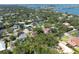 Aerial view of the home and neighborhood featuring lush green trees, beautiful water views, and a blue bridge at 1671 South Dr, Sarasota, FL 34239