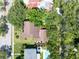 Aerial view of a home featuring lush green trees, well-maintained landscaping, and a neighboring pool at 1671 South Dr, Sarasota, FL 34239