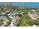 Aerial view of the home and neighborhood featuring lush green trees, beautiful water views, and a blue bridge at 1671 South Dr, Sarasota, FL 34239