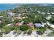 Aerial view of the home and neighborhood featuring lush green trees, beautiful water views, and stunning city skyline at 1671 South Dr, Sarasota, FL 34239