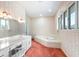 A full bathroom featuring a soaking tub and vanity at 1671 South Dr, Sarasota, FL 34239