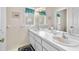 Bright bathroom featuring double sinks, ample countertop space, and classic fixtures at 1671 South Dr, Sarasota, FL 34239