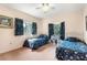 Bright bedroom with twin beds, floral bedding, and large window views at 1671 South Dr, Sarasota, FL 34239