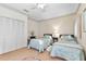 Cozy bedroom showcasing twin beds, a built-in closet, and classic floral wallpaper design at 1671 South Dr, Sarasota, FL 34239