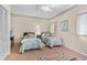 Charming bedroom featuring two twin beds, complemented by floral wallpaper and a ceiling fan at 1671 South Dr, Sarasota, FL 34239