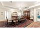 Elegant dining room with a large table, decorative chandelier, and built-in cabinet at 1671 South Dr, Sarasota, FL 34239