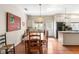 Inviting dining room with hardwood floors, stylish lighting, and adjacent kitchen area for easy entertaining at 1671 South Dr, Sarasota, FL 34239