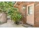 Brick exterior featuring a front door with a sidelight and manicured landscaping at 1671 South Dr, Sarasota, FL 34239
