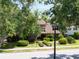 Beautiful home with lush landscaping, shade trees, and a well-manicured lawn at 1671 South Dr, Sarasota, FL 34239