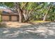 Charming home featuring mature shade trees, a brick exterior, and a two car garage at 1671 South Dr, Sarasota, FL 34239