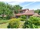 A charming house surrounded by beautiful landscaping on a sunny day with a blue sky at 1671 South Dr, Sarasota, FL 34239