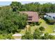 Charming home nestled among lush trees featuring a well-maintained lawn and inviting walkway at 1671 South Dr, Sarasota, FL 34239