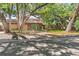 Charming home featuring mature shade trees, a brick exterior, and a two car garage at 1671 South Dr, Sarasota, FL 34239