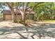 Charming home featuring mature shade trees, a brick exterior, and a two car garage at 1671 South Dr, Sarasota, FL 34239