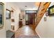Foyer features wood floors, staircase and decorative console table and wall art at 1671 South Dr, Sarasota, FL 34239