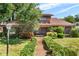 Charming two-story home with a well-manicured front yard and a welcoming front porch at 1671 South Dr, Sarasota, FL 34239