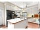 Well-lit kitchen with a central island, white countertops, ample storage, and modern appliances at 1671 South Dr, Sarasota, FL 34239