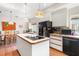 Kitchen featuring island with cooktop, ample storage and modern appliances at 1671 South Dr, Sarasota, FL 34239