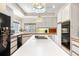Spacious kitchen island with cooktop, abundant cabinetry, and dual ovens for culinary enthusiasts at 1671 South Dr, Sarasota, FL 34239