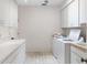 Functional laundry room with ample cabinet space and modern washer and dryer units at 1671 South Dr, Sarasota, FL 34239